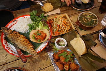 Thai papaya salad served with spicy soup, Grilled fish and fried chicken wings