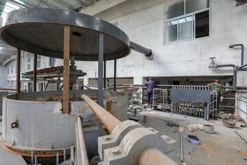 workers carry out civil construction in a factory building.