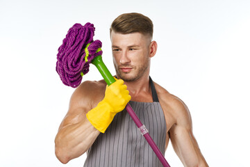 muscular man in a gray apron with a mop posing