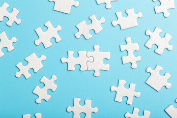  Puzzle pieces are connected. White puzzle pieces on a blue background. Business, partner,...