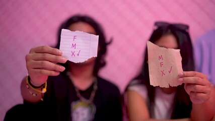 Non binary young latinos representing gender identity and fluidity. We are non-binary M stands for male, F for female and X for the third gender category. Individuality concept video.