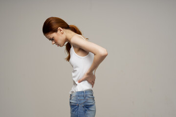 woman in white t-shirt chiropractic rheumatism health problems light background