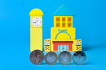 A coin in denomination of 100 Kazakhstani tenge, coins of 1 usd, 1 yuan, 1 euro and a conditional...