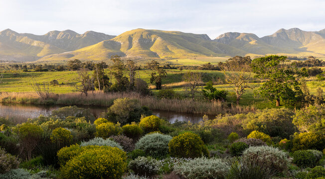 View across a tranquil landscape, river valley and a mountain range - Powered by Adobe