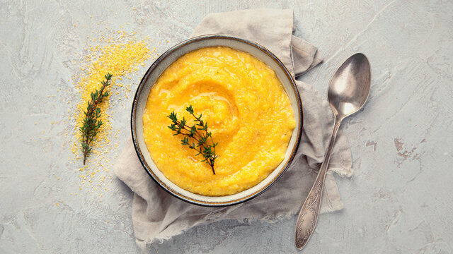 Corn polenta on gray background.