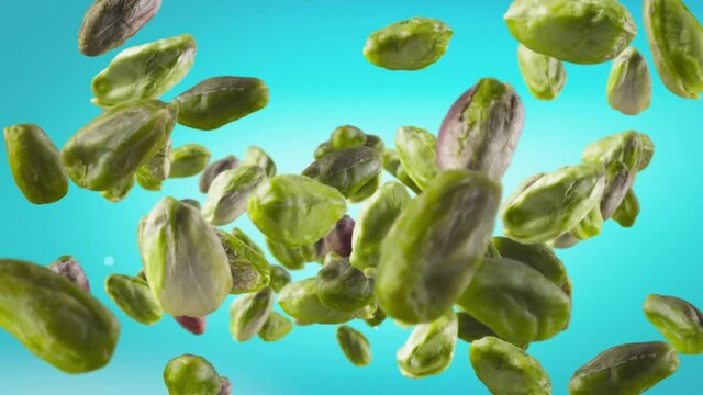 Flying of Peeled Pistachios in Ice Blue Background