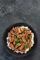 Bulgogi with meat on dark background.