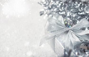 Silver Christmas gifts with snow background. silver decorations on pastel silver background. Flat...