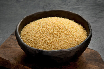 Couscous on dark background.