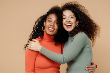 Two laughing bright young curly black women friends 20s wear casual shirts clothes looking camera...