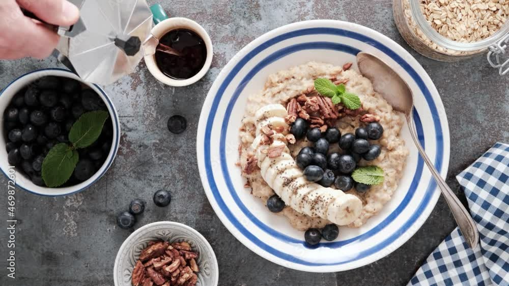 Sticker Breakfast table with oatmeal and fresh banana blueberries and pecans nuts