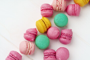 Pile of colorful macarons on white background