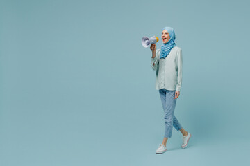 Full size young arabian asian muslim woman in abaya hijab hold scream in megaphone announces...