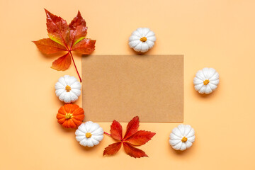 Orange, white, orange pumpkin and maple leaves isolated on beige background Top view Flat lay Hello autumn, happy thanksgiving concept Holiday card