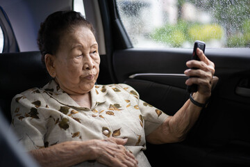 Very old Asian passenger woman age between 80 - 90 years old traveling by the car.