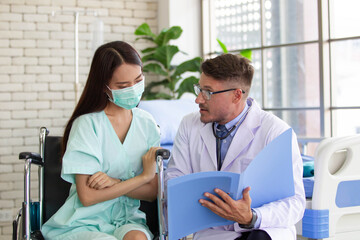 Fototapeta premium Asian woman got a sickness from covid-19 virus having a consultation with doctor in hospital.