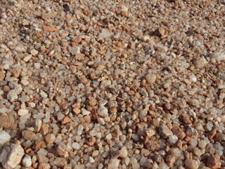 Brown small stone background . Small pieces of in the field. It material used in construction work