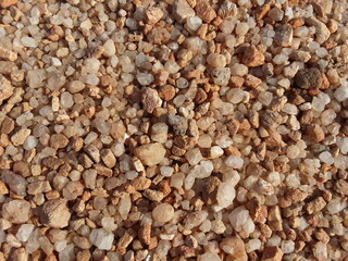 Brown small stone background . Small pieces of in the field. It material used in construction work