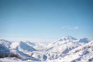 Fototapeta na wymiar Winter landscape. Vilyuchinsky volcano covered with snow against blue sky. Kamchatka peninsula, Russia