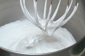 The process of making cream in a mixer. Selective focus.