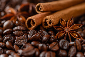 Close up shot of cinnamon sticks and anise star on coffee background.