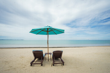 Beach with sunbed and Blue umbrella.