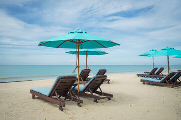 Beach with sunbed and Blue umbrella.