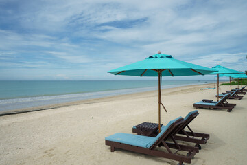 Beach with sunbed and Blue umbrella.