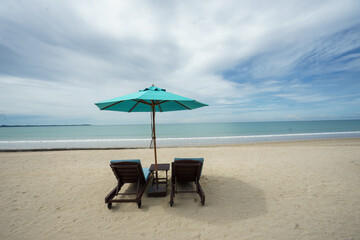 Beach with sunbed and Blue umbrella.