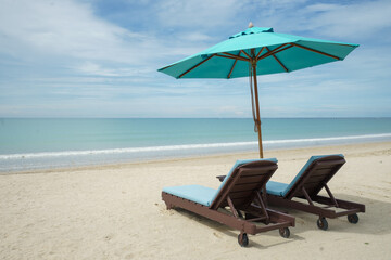 Beach with sunbed and Blue umbrella.