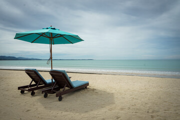 Beach with sunbed and Blue umbrella.