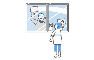 窓拭きをする親子