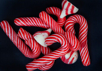 
small candy canes and red and white sweets with copy space
