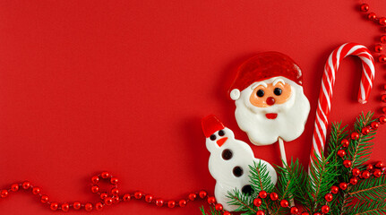 Christmas background with traditional candies on red. Flat lay, copy space