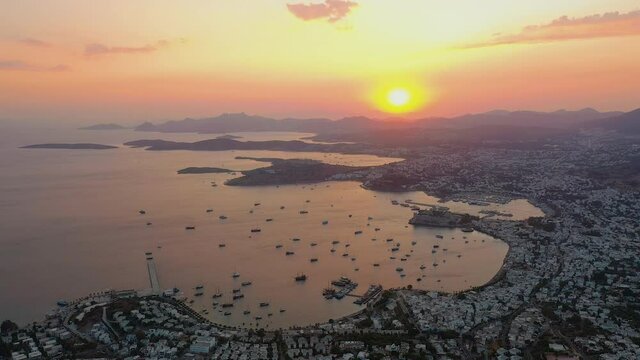Amazing panoramic aerial view from drone of Bodrum harbour at beautiful sunset, golden hour. Aegean sea, Kalesi castle, Mugla province in Turkey
