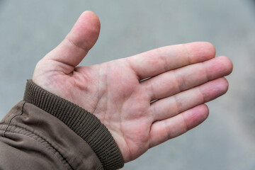 A man's palm and fingers on it