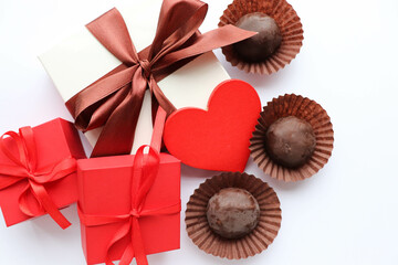 romantic composition for valentine's day. red heart, gift box and chocolates 