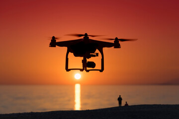 Fototapeta na wymiar Silhouette of a quadrocopter on sunset background