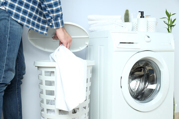 Concept of housework with washing machine and guy on white background