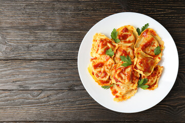 Delicious food concept with ravioli on wooden table