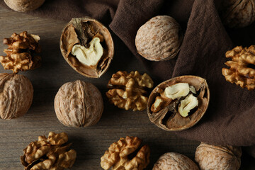 Walnuts with kitchen towel on wooden background