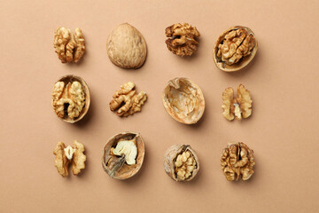 Flat lay composition with walnuts on brown background