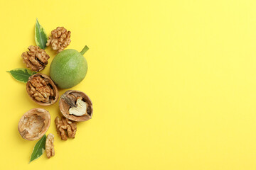 Walnuts with nut peel on yellow background
