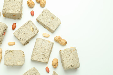 Halva with nuts on white background, space for text