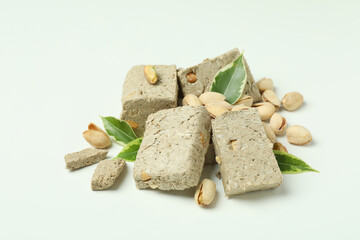 Halva with pistachio and leaves on white background