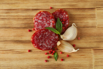 Сoncept of tasty food with salami sausage on wooden background