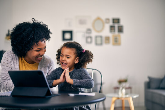 Little Girl Learning How To Read, With Her Mother