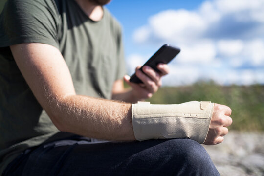 Injured man with smart phone