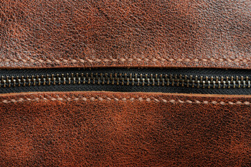 Zip lock on brown leather background