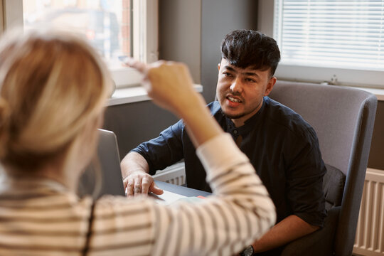 Coworkers talking in office